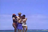 A lucky man on the beach with two ebony nymphs